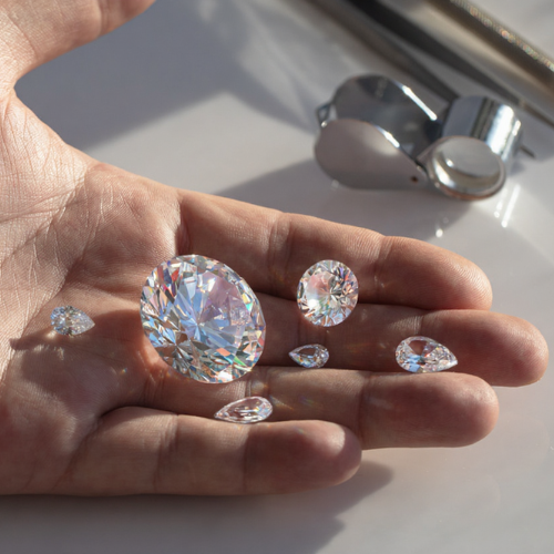 Hand holding loose diamonds